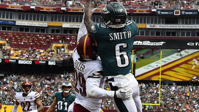 Sep 25, 2022; Landover, Maryland, USA; Philadelphia Eagles wide receiver DeVonta Smith (6) scores a touchdown over Washington Commanders cornerback Kendall Fuller (29) before the game between the Washington Commanders and the Philadelphia Eagles at FedExField. Mandatory Credit: Brad Mills-USA TODAY Sports