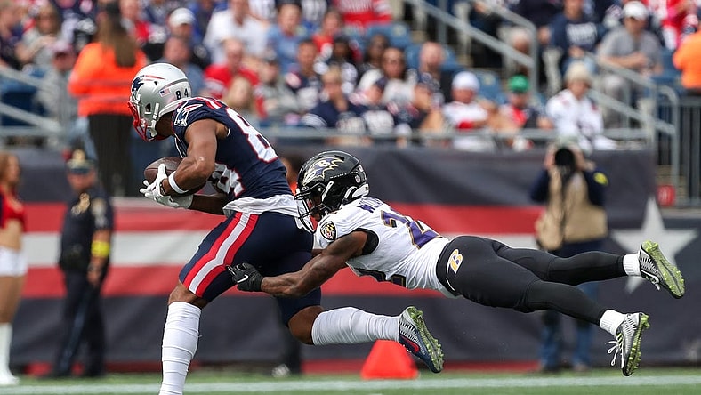 Sep 25, 2022; Foxborough, Massachusetts, USA; Baltimore Ravens cornerback Damarion Williams (22) tackles New England Patriots receiver Kendrick Bourne (84) during the first half at Gillette Stadium. Mandatory Credit: Paul Rutherford-USA TODAY Sports