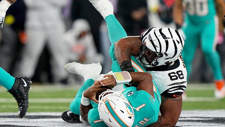 Sep 29, 2022; Cincinnati, Ohio, USA; Cincinnati Bengals defensive tackle Josh Tupou (68) sacks Miami Dolphins quarterback Tua Tagovailoa (1) in the second quarter at Paycor Stadium in Cincinnati. Tagovailoa sustained a head injury on the play and left the game for treatment. Mandatory Credit: Kareem Elgazzar-USA TODAY Sports