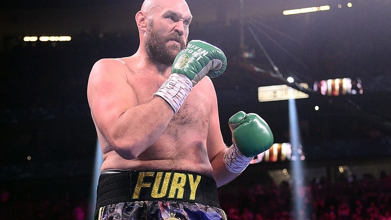 Oct 9, 2021; Las Vegas, Nevada, USA; Deontay Wilder (red/black trunks) and Tyson Fury (black/gold trunks) box during their WBC/Lineal heavyweight championship boxing match at T-Mobile Arena. Mandatory Credit: Joe Camporeale-USA TODAY Sports