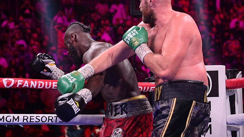 Oct 9, 2021; Las Vegas, Nevada, USA; Deontay Wilder (red/black trunks) is knocked out by Tyson Fury (black/gold trunks) during their WBC/Lineal heavyweight championship boxing match at T-Mobile Arena. Mandatory Credit: Joe Camporeale-USA TODAY Sports