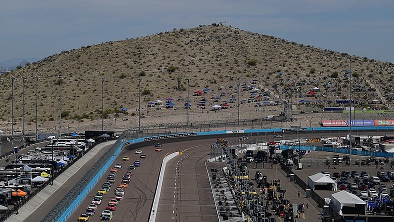 Mar 13, 2022; Avondale, Arizona, USA; General view as NASCAR Cup Series driver Kyle Busch (18) and driver Ryan Blaney (12) lead the field for the restart of the Ruoff Mortgage 500 at Phoenix Raceway. Mandatory Credit: Gary A. Vasquez-USA TODAY Sports