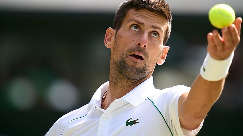 Jul 5, 2022; London, England, United Kingdom; Novak Djokovic (SRB) serves against Jannik Sinner (ITA) during a quarterfinals mens singles match on Centre court at the 2022 Wimbledon Championships at All England Lawn Tennis and Croquet Club. Mandatory Credit: Peter van den Berg-USA TODAY Sports