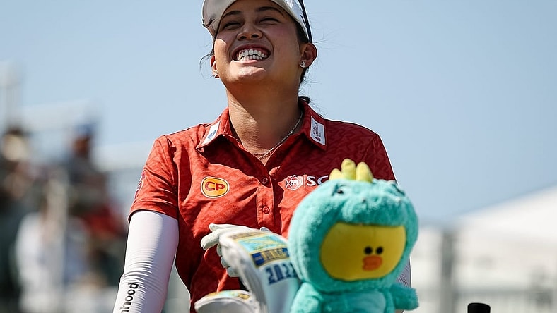Jun 26, 2022; Bethesda, Maryland, USA; Atthaya Thitikul laughs from the first tee during the final round of the KPMG Women's PGA Championship golf tournament at Congressional Country Club. Mandatory Credit: Scott Taetsch-USA TODAY Sports