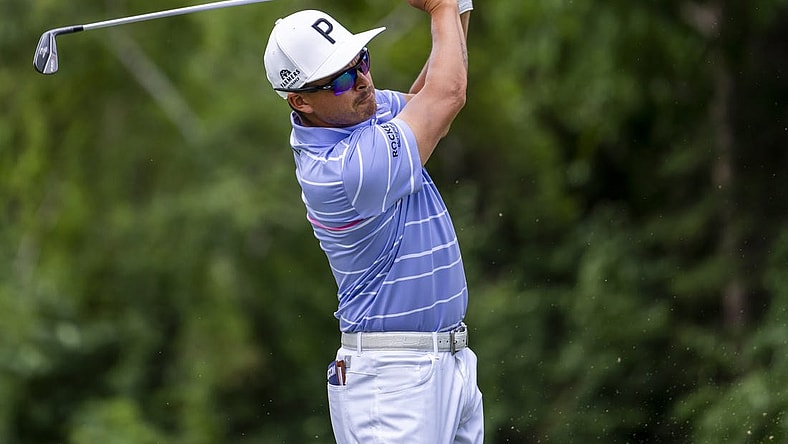 Jul 29, 2022; Detroit, Michigan, USA; Rickie Fowler hits his tee shot on the par 3 ninth hole during the second round of the Rocket Mortgage Classic golf tournament. Mandatory Credit: Raj Mehta-USA TODAY Sports