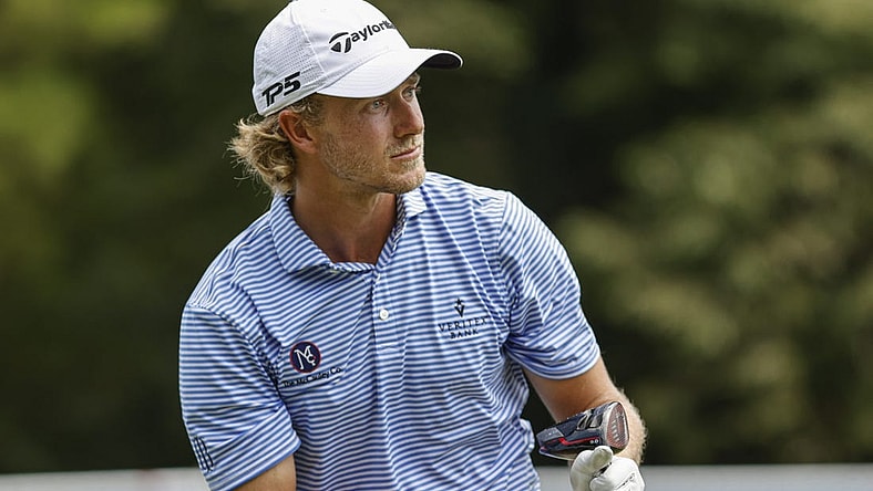 Aug 4, 2022; Greensboro, North Carolina, USA; Austin Smotherman watches his tee shot on the 18th tee during the first round of the Wyndham Championship golf tournament. Mandatory Credit: Nell Redmond-USA TODAY Sports