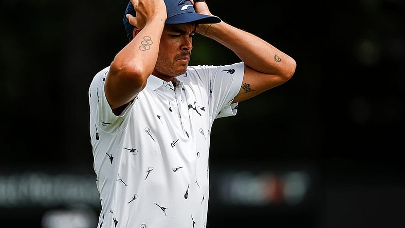 Rickie Fowler puts on his cap as he walks off the 9th green during Round 1 of the Rocket Mortgage Classic at the Detroit Golf Club in Detroit on Thurs., July 28, 2022.

Syndication Detroit Free Press