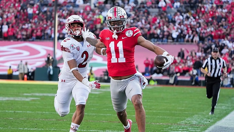 Ohio State wide receiver Jaxon Smith-Njigba fends off Utah cornerback Micah Bernard as he races to the end zone for a touchdown during the second quarter of the 2022 Rose Bowl in Pasadena, Calif.

2022-08-23-smith-njigba