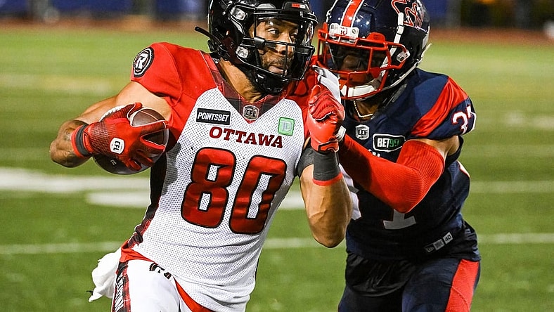 Sep 2, 2022; Montreal, Quebec, CAN; Montreal Alouettes defensive back Wesley Sutton (37) tackles Ottawa Redblacks wide receiver Nate Behar (80) during the fourth quarter at Percival Molson Memorial Stadium. Mandatory Credit: David Kirouac-USA TODAY Sports