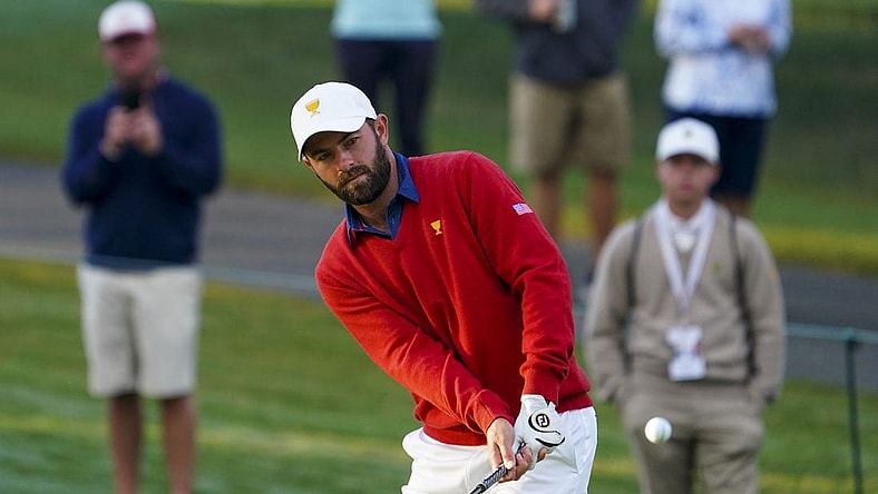Sep 24, 2022; Charlotte, North Carolina, USA; Team USA golfer Cameron Young hits a chip shot on the third green during the foursomes match play of the Presidents Cup golf tournament at Quail Hollow Club. Mandatory Credit: Peter Casey-USA TODAY Sports