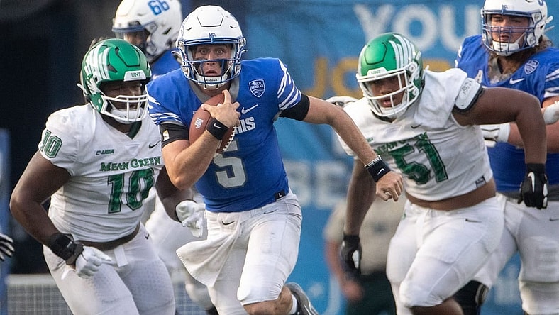 Memphis Tigers quarterback Seth Henigan (5) keeps hold of the ball as North Texas Mean Green defensive tackle Roderick Brown (10) and North Texas Mean Green defensive lineman Fatafehi Vailea (51) guard him during a Memphis Tigers game against the North Texas Mean Green on Saturday, Sept. 24, 2022, at Simmons Bank Liberty Stadium in Memphis. Memphis defeated North Texas 44-34.
