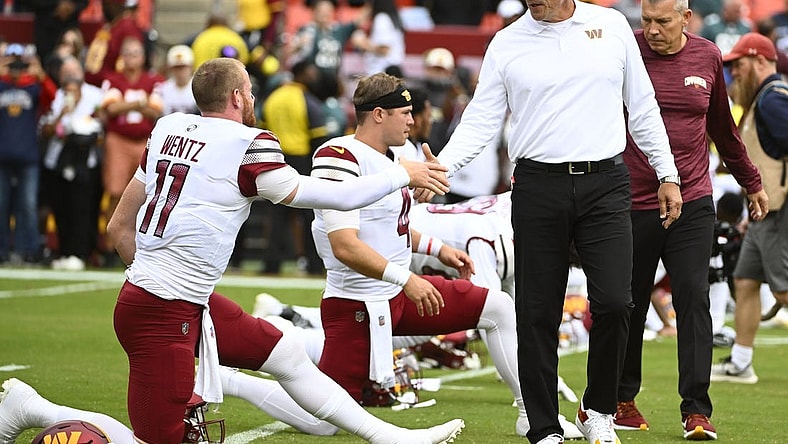 Sep 25, 2022; Landover, Maryland, USA; Washington Commanders head coach Ron Rivera greets quarterback Carson Wentz (11) before the game between the Washington Commanders and the Philadelphia Eagles at FedExField. Mandatory Credit: Brad Mills-USA TODAY Sports