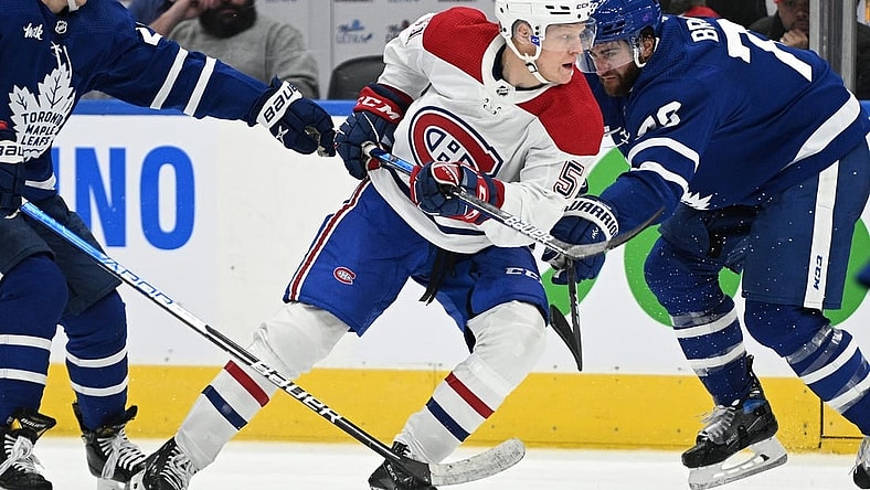 Sep 28, 2022; Toronto, Ontario, CAN; Montreal Canadiens forward Emil Heineman (51) moves past Toronto Maple Leafs defenseman TJ Brodie (78) in the third period at Scotiabank Arena. Mandatory Credit: Dan Hamilton-USA TODAY Sports