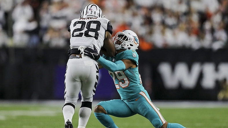 Sep 29, 2022; Cincinnati, Ohio, USA; Cincinnati Bengals running back Joe Mixon (28) runs with the ball against Miami Dolphins safety Brandon Jones (29) in the first half at Paycor Stadium. Mandatory Credit: Katie Stratman-USA TODAY Sports