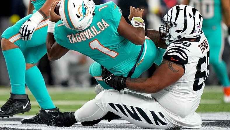 Sep 29, 2022; Cincinnati, Ohio, USA; Cincinnati Bengals defensive tackle Josh Tupou (68) sacks Miami Dolphins quarterback Tua Tagovailoa (1) in the second quarter at Paycor Stadium in Cincinnati. Tagovailoa sustained a head injury on the play and left the game for treatment. Mandatory Credit: Kareem Elgazzar-USA TODAY Sports