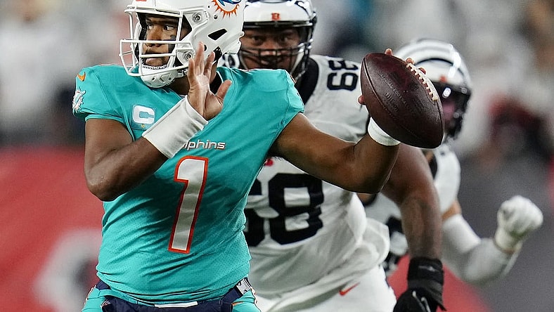 Sep 29, 2022; Cincinnati, Ohio, USA; Miami Dolphins quarterback Tua Tagovailoa (1) is pursued by Cincinnati Bengals defensive tackle Josh Tupou (68) in the second quarter against the Cincinnati Bengals at Paycor Stadium. Mandatory Credit: Sam Greene/Cincinnati Enquirer via USA TODAY NETWORK