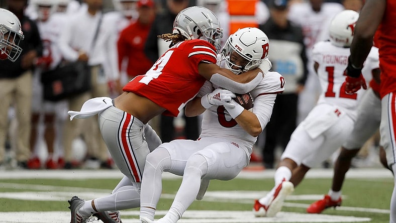 Oct 1, 2022; Columbus, Ohio, USA;  Ohio State Buckeyes safety Ronnie Hickman (14) tackles Rutgers Scarlet Knights quarterback Noah Vedral (0) for a loss during the first quarter at Ohio Stadium. Mandatory Credit: Joseph Maiorana-USA TODAY Sports