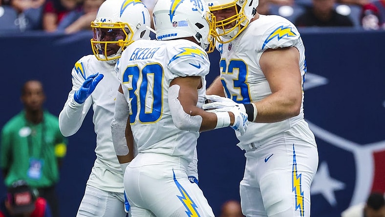 Oct 2, 2022; Houston, Texas, USA;  Los Angeles Chargers running back Austin Ekeler (30) celebrates with Los Angeles Chargers center Corey Linsley (63) after running for a touchdown  during the second quarter against the Houston Texans at NRG Stadium. Mandatory Credit: Kevin Jairaj-USA TODAY Sports