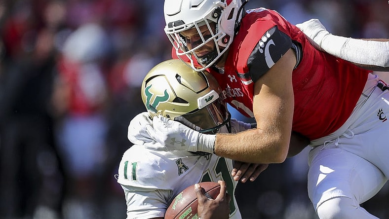 Oct 8, 2022; Cincinnati, Ohio, USA; Cincinnati Bearcats linebacker Wilson Huber (2) sacks South Florida Bulls quarterback Gerry Bohanon (11) in the first half at Nippert Stadium. Mandatory Credit: Katie Stratman-USA TODAY Sports