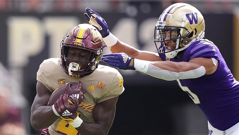 Oct 8, 2022; Tempe, Arizona, USA; Arizona State Sun Devils running back Daniyel Ngata (4) runs against Washington Huskies safety Alex Cook (5) during the first half at Sun Devil Stadium. Mandatory Credit: Joe Camporeale-USA TODAY Sports