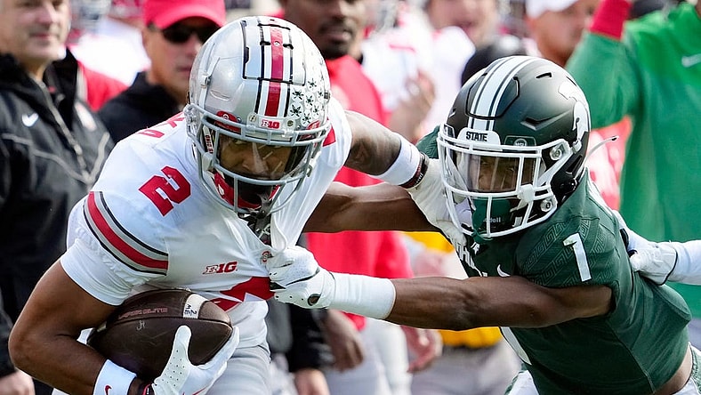 Oct 8, 2022; East Lansing, Michigan, USA; Ohio State Buckeyes wide receiver Emeka Egbuka (2) gets tackled by Michigan State Spartans safety Jaden Mangham (1) after a catch in the first quarter of the NCAA Division I football game between the Ohio State Buckeyes and Michigan State Spartans at Spartan Stadium.

Osu22msu Kwr 22