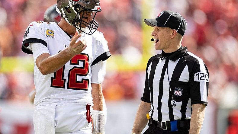 Oct 9, 2022; Tampa, Florida, USA; Tampa Bay Buccaneers quarterback Tom Brady (12) discusses a call with side judge Jonah Monroe (120) during the second half against the Atlanta Falcons at Raymond James Stadium. Mandatory Credit: Matt Pendleton-USA TODAY Sports