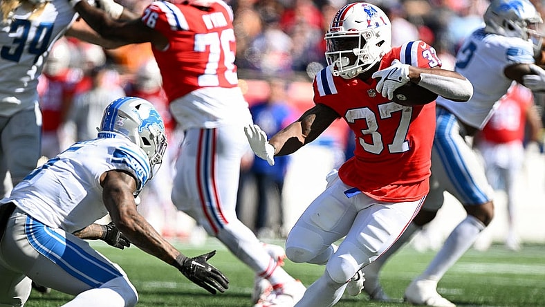 Oct 9, 2022; Foxborough, Massachusetts, USA; New England Patriots running back Damien Harris (37) runs against Detroit Lions safety DeShon Elliott (5) during the first half at Gillette Stadium. Mandatory Credit: Brian Fluharty-USA TODAY Sports