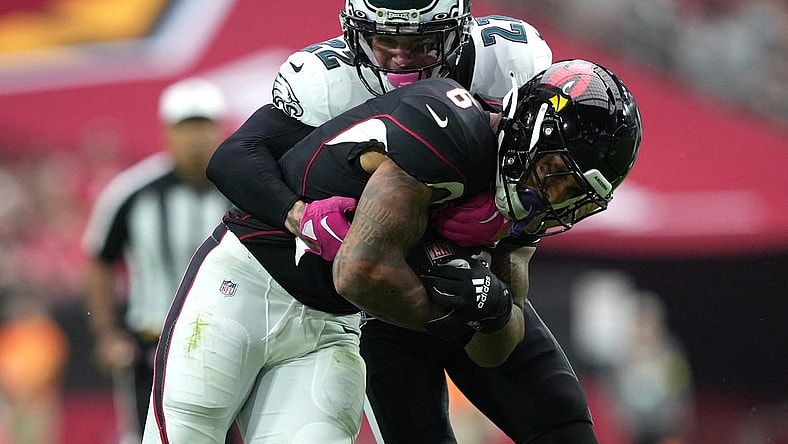 Oct 9, 2022; Glendale, Arizona, USA; Philadelphia Eagles safety Marcus Epps (22) tackles Arizona Cardinals running back James Conner (6) during the first half at State Farm Stadium. Mandatory Credit: Joe Camporeale-USA TODAY Sports