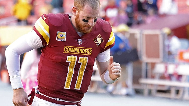 Oct 9, 2022; Landover, Maryland, USA; Washington Commanders quarterback Carson Wentz (11) jogs off the field after the Commanders' game against the Tennessee Titans at FedExField. Mandatory Credit: Geoff Burke-USA TODAY Sports