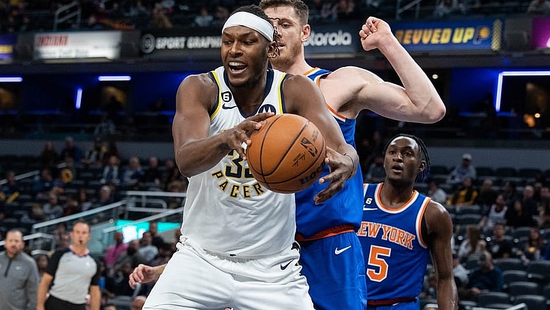 Oct 12, 2022; Indianapolis, Indiana, USA; Indiana Pacers center Myles Turner (33) rebounds the ball over New York Knicks center Isaiah Hartenstein (55) in the first half at Gainbridge Fieldhouse. Mandatory Credit: Trevor Ruszkowski-USA TODAY Sports