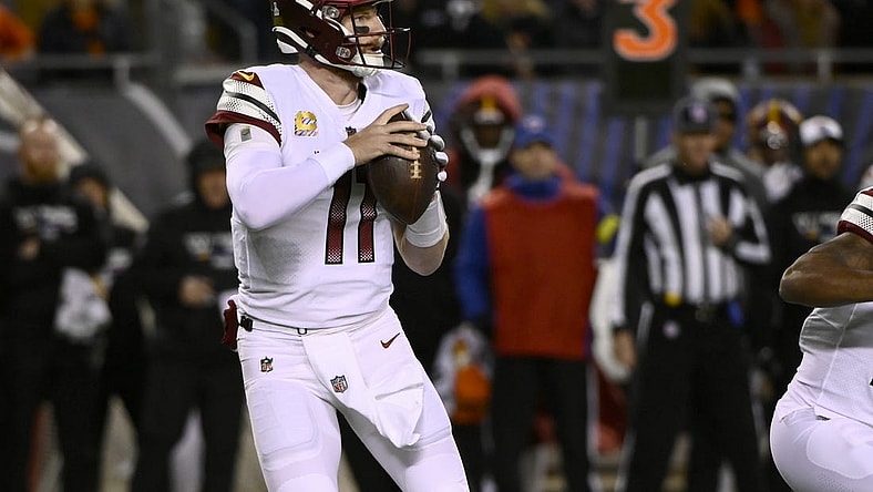 Oct 13, 2022; Chicago, Illinois, USA; Washington Commanders quarterback Carson Wentz (11) looks to pass against the Chicago Bears during the first half at Soldier Field. Mandatory Credit: Matt Marton-USA TODAY Sports