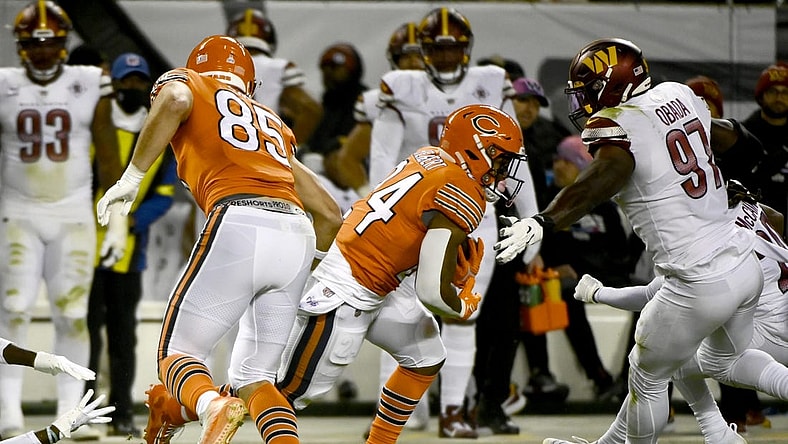 Oct 13, 2022; Chicago, Illinois, USA; Chicago Bears running back Khalil Herbert (24) runs past Washington Commanders defensive end Efe Obada (97) during the first half at Soldier Field. Mandatory Credit: Matt Marton-USA TODAY Sports
