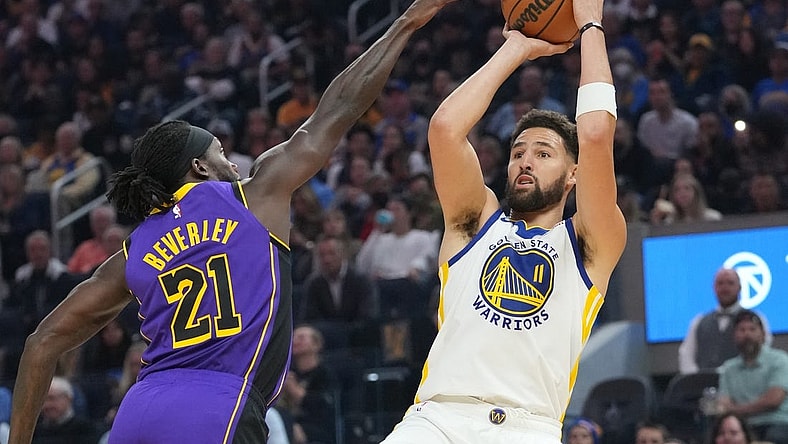October 18, 2022; San Francisco, California, USA; Golden State Warriors guard Klay Thompson (11) shoots the basketball against Los Angeles Lakers guard Patrick Beverley (21) during the first quarter at Chase Center. Mandatory Credit: Kyle Terada-USA TODAY Sports