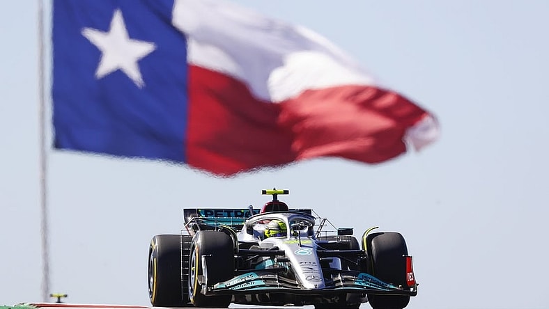 Oct 21, 2022; Austin, Texas, USA;  Mercedes-AMG Petronas driver Lewis Hamilton (44) passes the Texas flag during practice for the U.S. Grand Prix at Circuit of the Americas. Mandatory Credit: Erich Schlegel-USA TODAY Sports