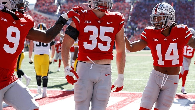 Oct 22, 2022; Columbus, Ohio, USA;  Ohio State Buckeyes linebacker Tommy Eichenberg (35) celebrates his interception return for a touchdown with safety Ronnie Hickman (14) and defensive end Zach Harrison (9) during the second quarter against the Iowa Hawkeyes at Ohio Stadium. Mandatory Credit: Joseph Maiorana-USA TODAY Sports