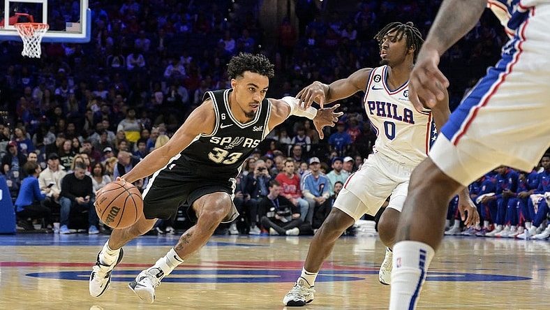 Oct 22, 2022; Philadelphia, Pennsylvania, USA;  San Antonio Spurs guard Tre Jones (33) moves to the net as Philadelphia 76ers guard Tyrese Maxey (0) defends during the first quarter of the game at Wells Fargo Center. Mandatory Credit: John Geliebter-USA TODAY Sports
