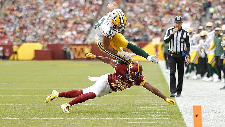 Oct 23, 2022; Landover, Maryland, USA; Green Bay Packers wide receiver Allen Lazard (13) leaps over Washington Commanders cornerback Kendall Fuller (29) while attempting to score a touchdown during the first quarter at FedExField. Mandatory Credit: Geoff Burke-USA TODAY Sports