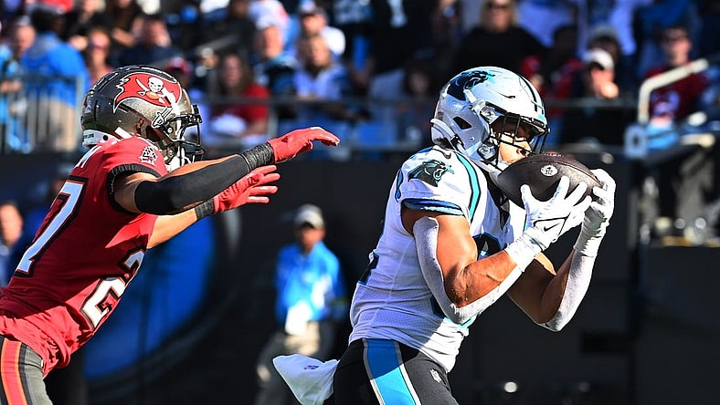 Oct 23, 2022; Charlotte, North Carolina, USA; Carolina Panthers tight end Tommy Tremble (82) catches a touchdown as Tampa Bay Buccaneers cornerback Zyon McCollum (27) defends in the fourth quarter at Bank of America Stadium. Mandatory Credit: Bob Donnan-USA TODAY Sports