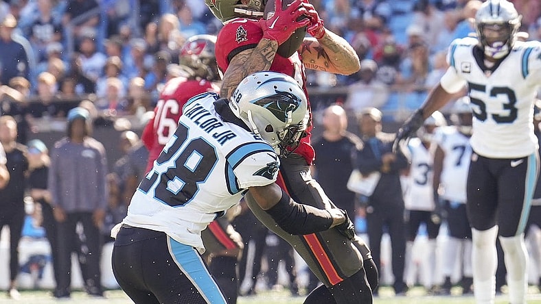 Oct 23, 2022; Charlotte, North Carolina, USA; Tampa Bay Buccaneers wide receiver Mike Evans (13) is hit as he makes a catch by Carolina Panthers cornerback Keith Taylor Jr. (28) during the second half at Bank of America Stadium. Mandatory Credit: Jim Dedmon-USA TODAY Sports