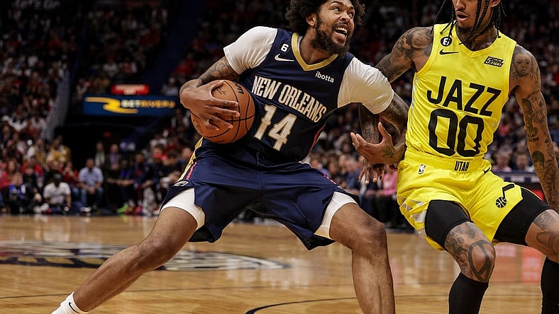 Oct 23, 2022; New Orleans, Louisiana, USA; New Orleans Pelicans forward Brandon Ingram (14) dribbles against Utah Jazz guard Jordan Clarkson (00) during the first half at Smoothie King Center. Mandatory Credit: Stephen Lew-USA TODAY Sports