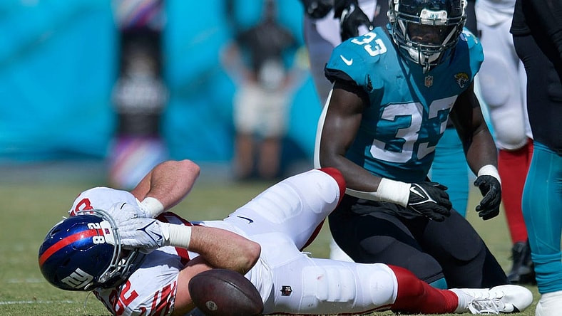 New York Giants tight end Daniel Bellinger (82) grabs his face after a tackle by Jacksonville Jaguars linebacker Devin Lloyd (33) which took Bellinger out of the game with an injury to his face late in the second quarter. The Jacksonville Jaguars hosted the New York Giants at TIAA Bank Field in Jacksonville, FL Sunday, October 23, 2022. The Jaguars trailed at the half 11 to 13. [Bob Self/Florida Times-Union]

Jki 102322 Hsfb Bs Jaguars Vs Giants 46