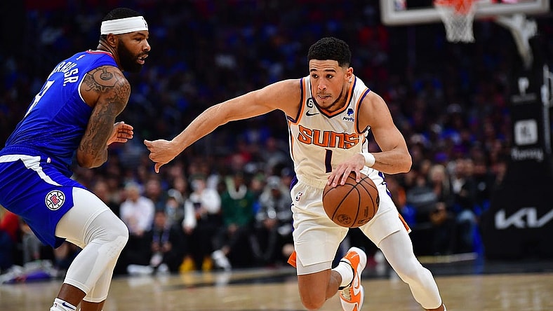 Oct 23, 2022; Los Angeles, California, USA; Phoenix Suns guard Devin Booker (1) moves the ball against Los Angeles Clippers forward Marcus Morris Sr. (8) during the first half at Crypto.com Arena. Mandatory Credit: Gary A. Vasquez-USA TODAY Sports