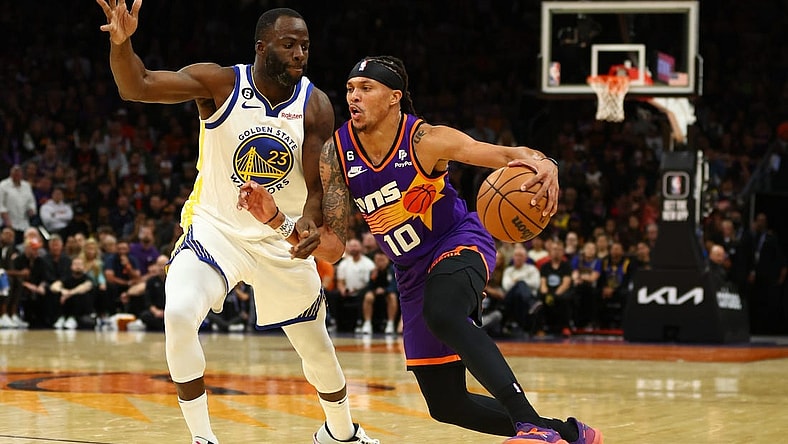 Oct 25, 2022; Phoenix, Arizona, USA; Phoenix Suns guard Damion Lee (10) moves the ball against Golden State Warriors forward Draymond Green (23) in the first half at Footprint Center. Mandatory Credit: Mark J. Rebilas-USA TODAY Sports