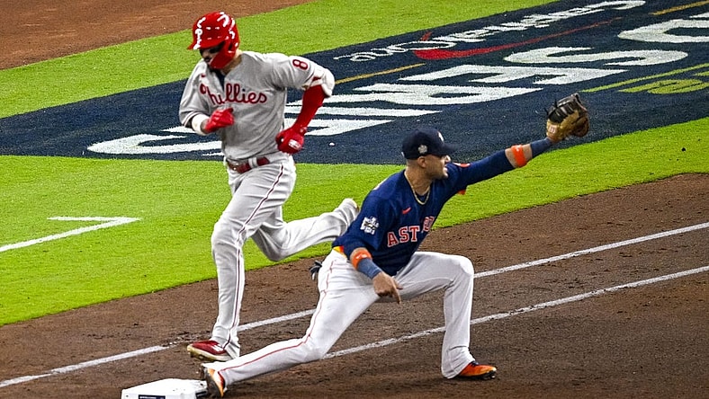 Oct 29, 2022; Houston, Texas, USA; Houston Astros first baseman Yuli Gurriel (10) puts out Philadelphia Phillies right fielder Nick Castellanos (8) at first base during the fourth inning during game two of the 2022 World Series at Minute Maid Park. Mandatory Credit: Jerome Miron-USA TODAY Sports