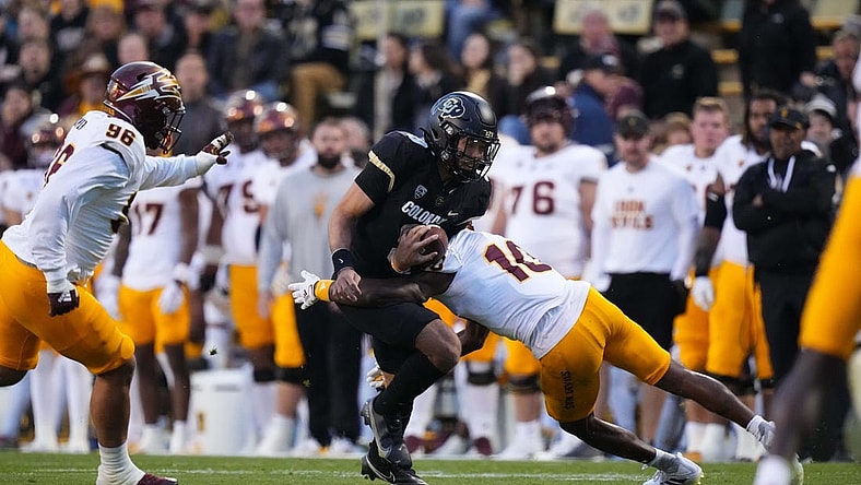 Oct 29, 2022; Boulder, Colorado, USA; Arizona State Sun Devils defensive back Ed Woods (10) tackles Colorado Buffaloes quarterback Drew Carter (9) in the first quarter at Folsom Field. Mandatory Credit: Ron Chenoy-USA TODAY Sports