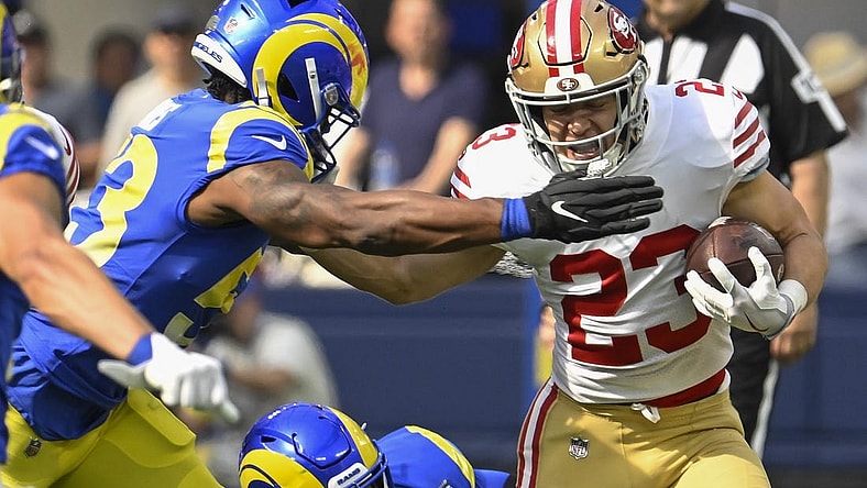 Oct 30, 2022; Inglewood, California, USA; San Francisco 49ers running back Christian McCaffrey (23) stiff arms Los Angeles Rams linebacker Ernest Jones (53) in the first quarter at SoFi Stadium. Mandatory Credit: Robert Hanashiro-USA TODAY Sports