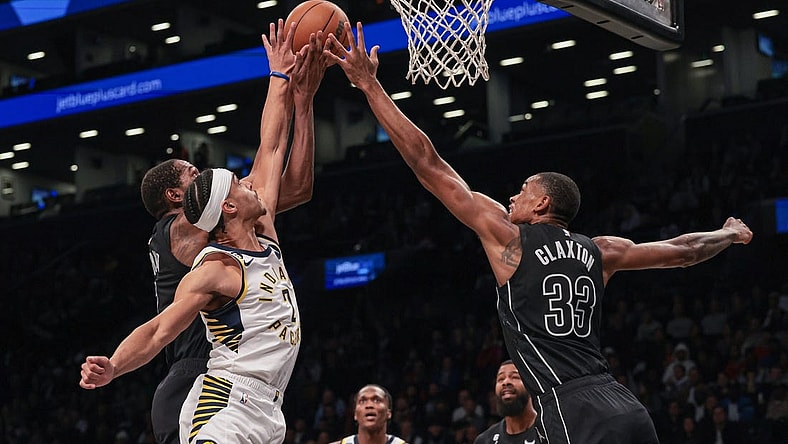 Oct 31, 2022; Brooklyn, New York, USA; Indiana Pacers guard Andrew Nembhard (2) battles Brooklyn Nets forward Kevin Durant (7) and forward Nic Claxton (33) for the ball during the first half at Barclays Center. Mandatory Credit: Vincent Carchietta-USA TODAY Sports
