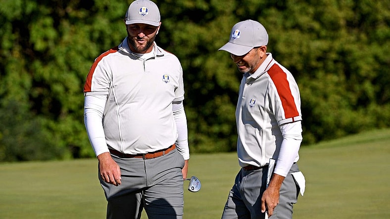 Sep 25, 2021; Haven, Wisconsin, USA; Team Europe player Jon Rahm and Team Europe player Rory McIlroy react on the ninth green during day two four-ball rounds for the 43rd Ryder Cup golf competition at Whistling Straits. Mandatory Credit: Orlando Ramirez-USA TODAY Sports