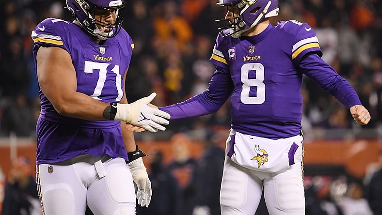 Dec 20, 2021; Chicago, Illinois, USA; Minnesota Vikings quarterback Kirk Cousins (8) and Minnesota Vikings offensive tackle Christian Darrisaw (71) celebrate after the touchdown in the second half against the Chicago Bears at Soldier Field. Mandatory Credit: Quinn Harris-USA TODAY Sports