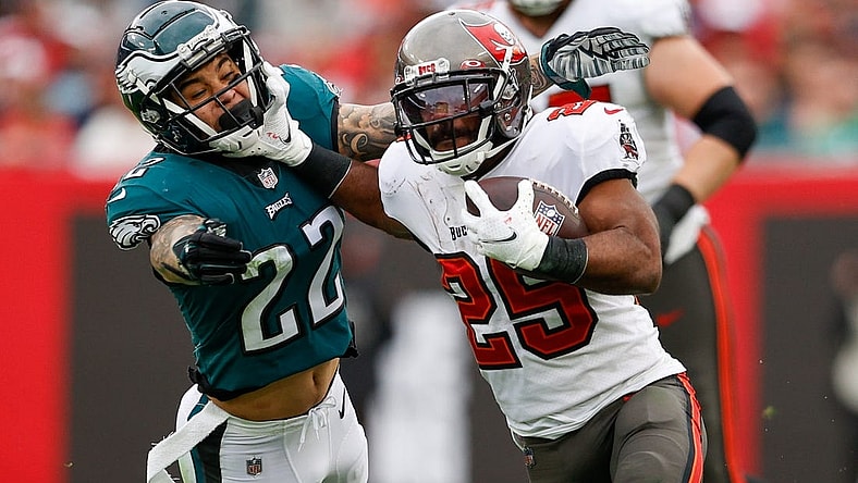 Jan 16, 2022; Tampa, Florida, USA; Tampa Bay Buccaneers running back Giovani Bernard (25) holds off Philadelphia Eagles free safety Marcus Epps (22) in the third quarter in a NFC Wild Card playoff football game at Raymond James Stadium. Mandatory Credit: Nathan Ray Seebeck-USA TODAY Sports